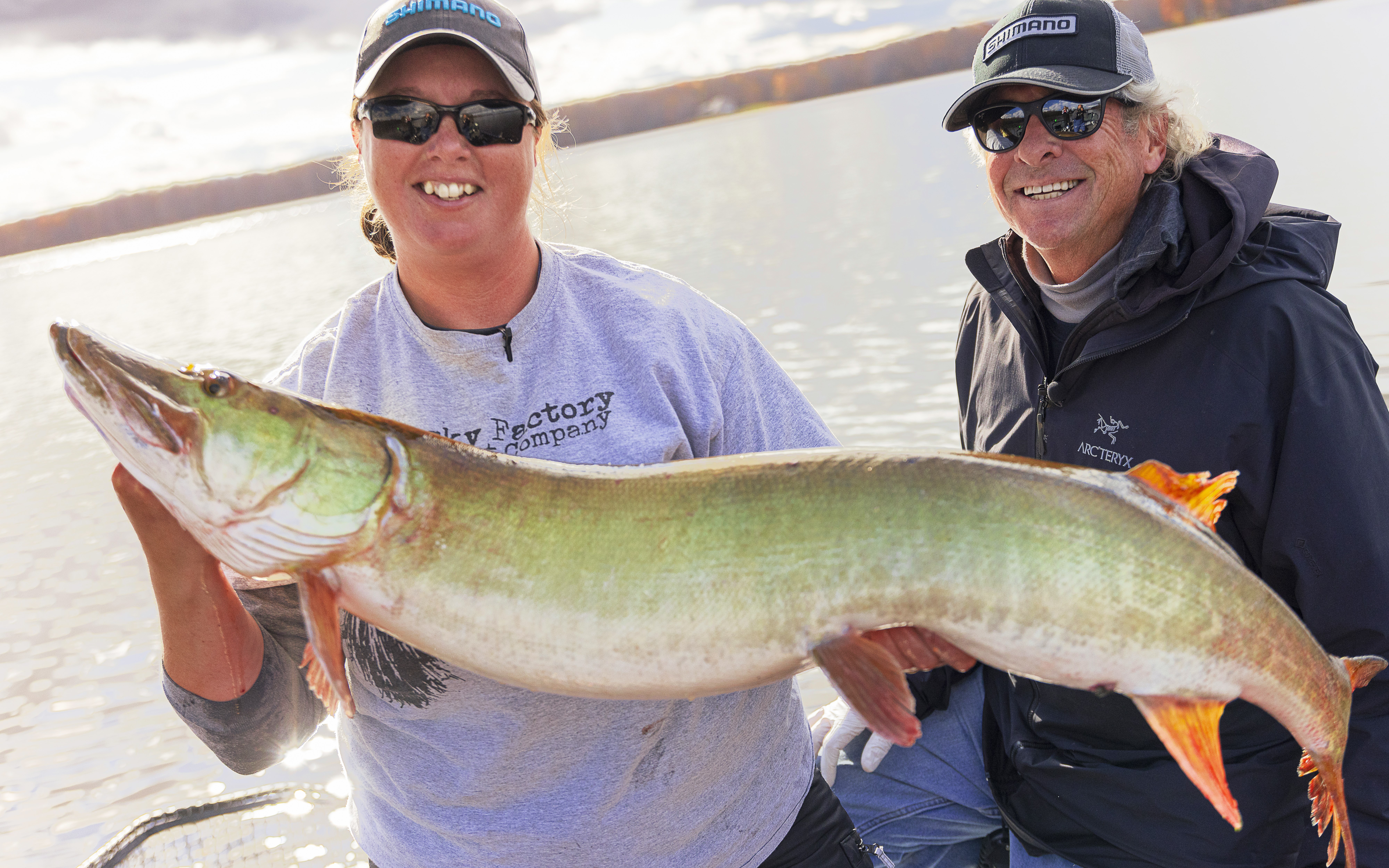 Two visitors holding a big musky in their hands on the Ottawa River