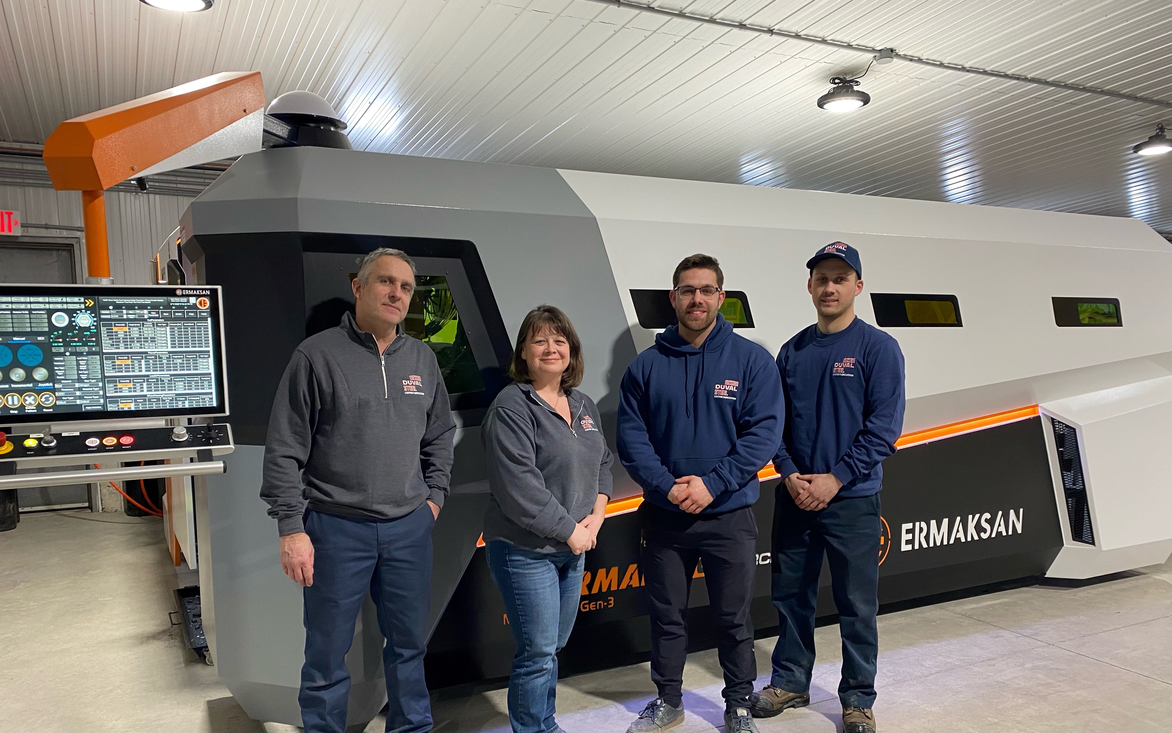 Four staff members of family owned local business Acier Duval Steel in front of their new Fiber Laser machine