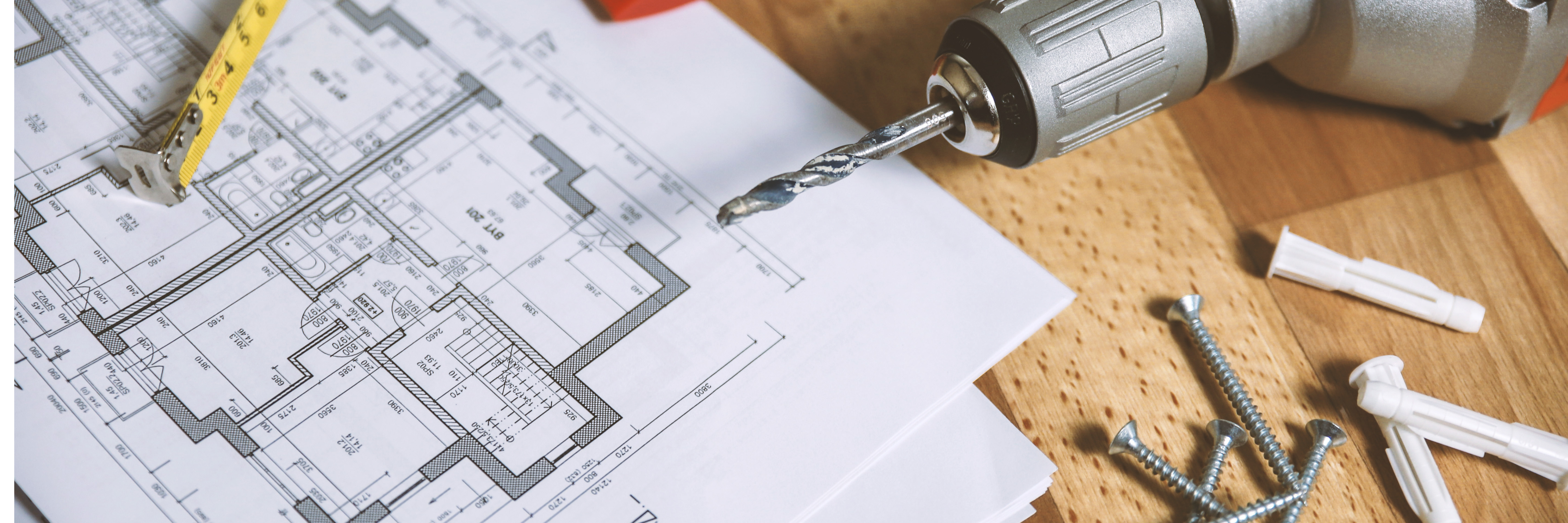 A drill, a house plan and a pencil