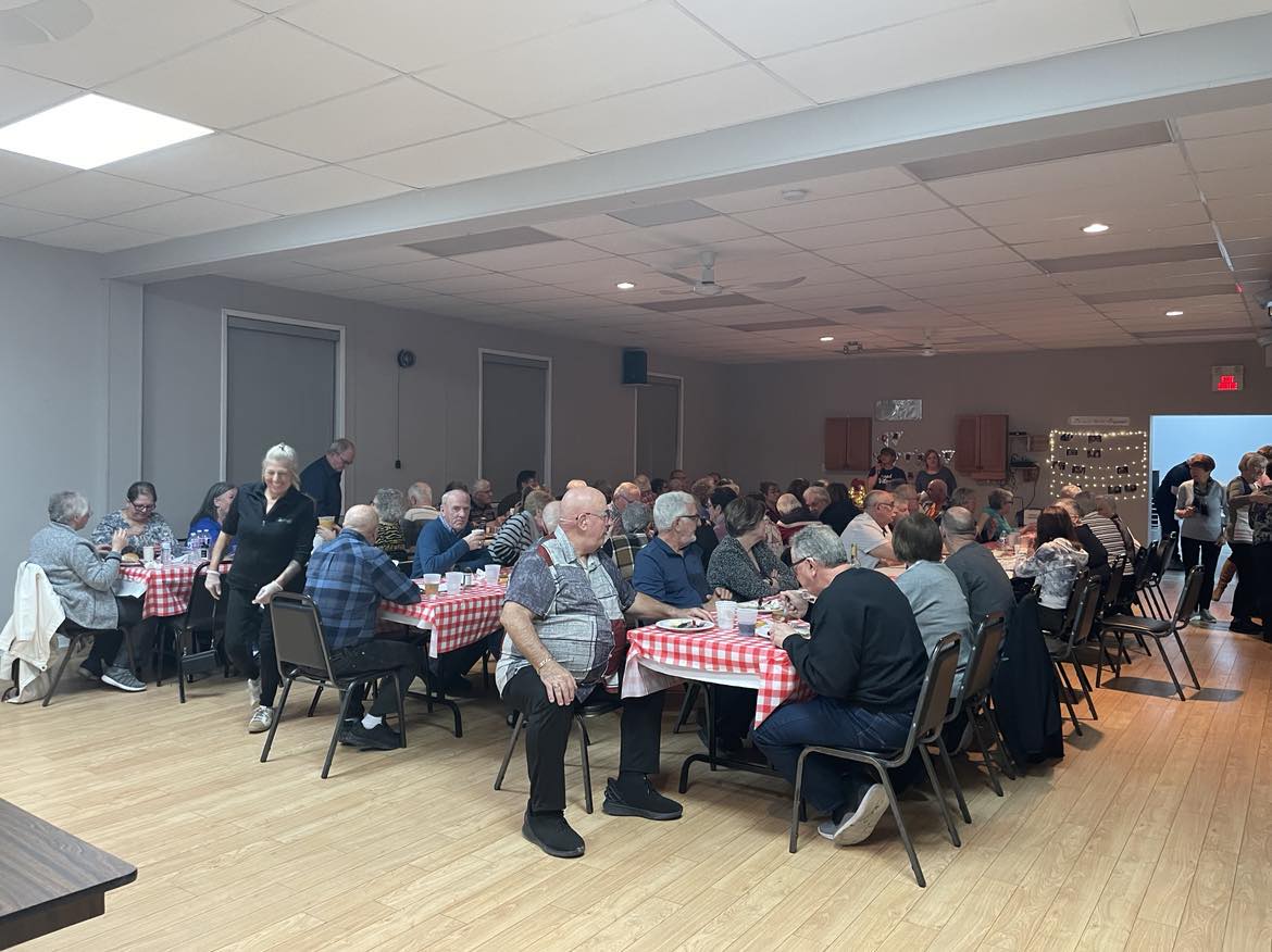 The Treadwell Community Centre filled with people seated at tables.