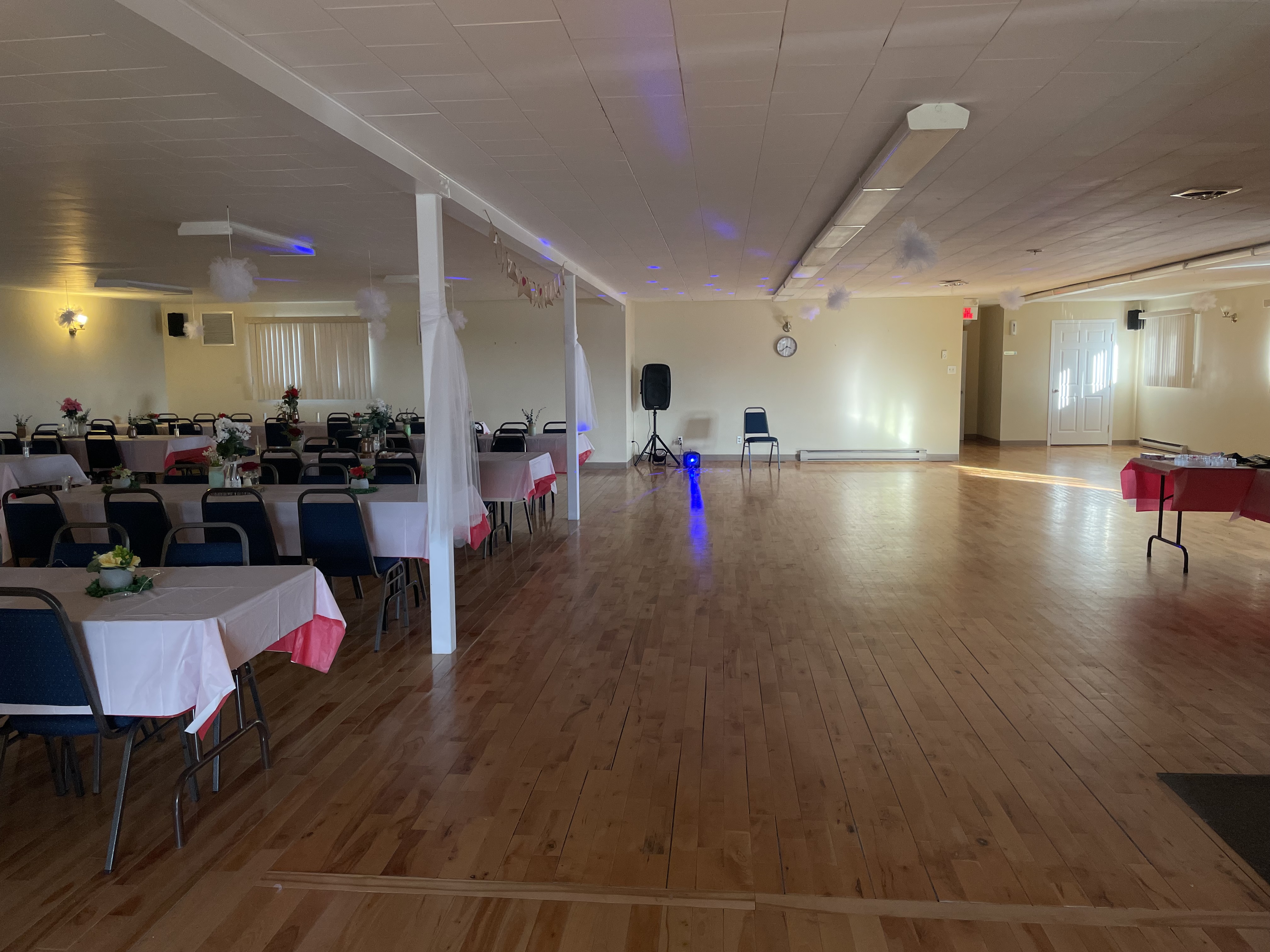 Tables on one side and a dancefloor on the other