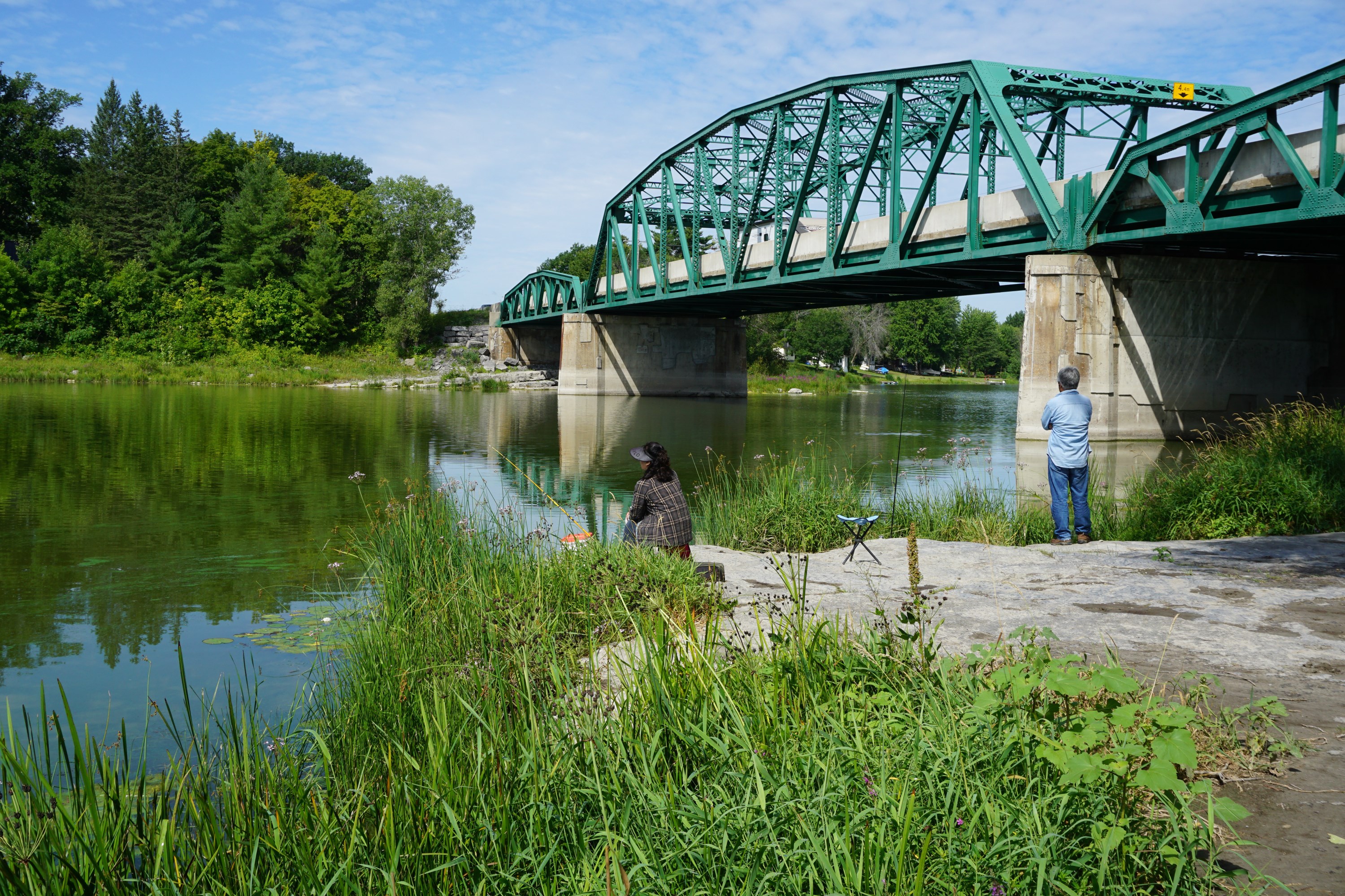 Bridge with 2 people fishing 