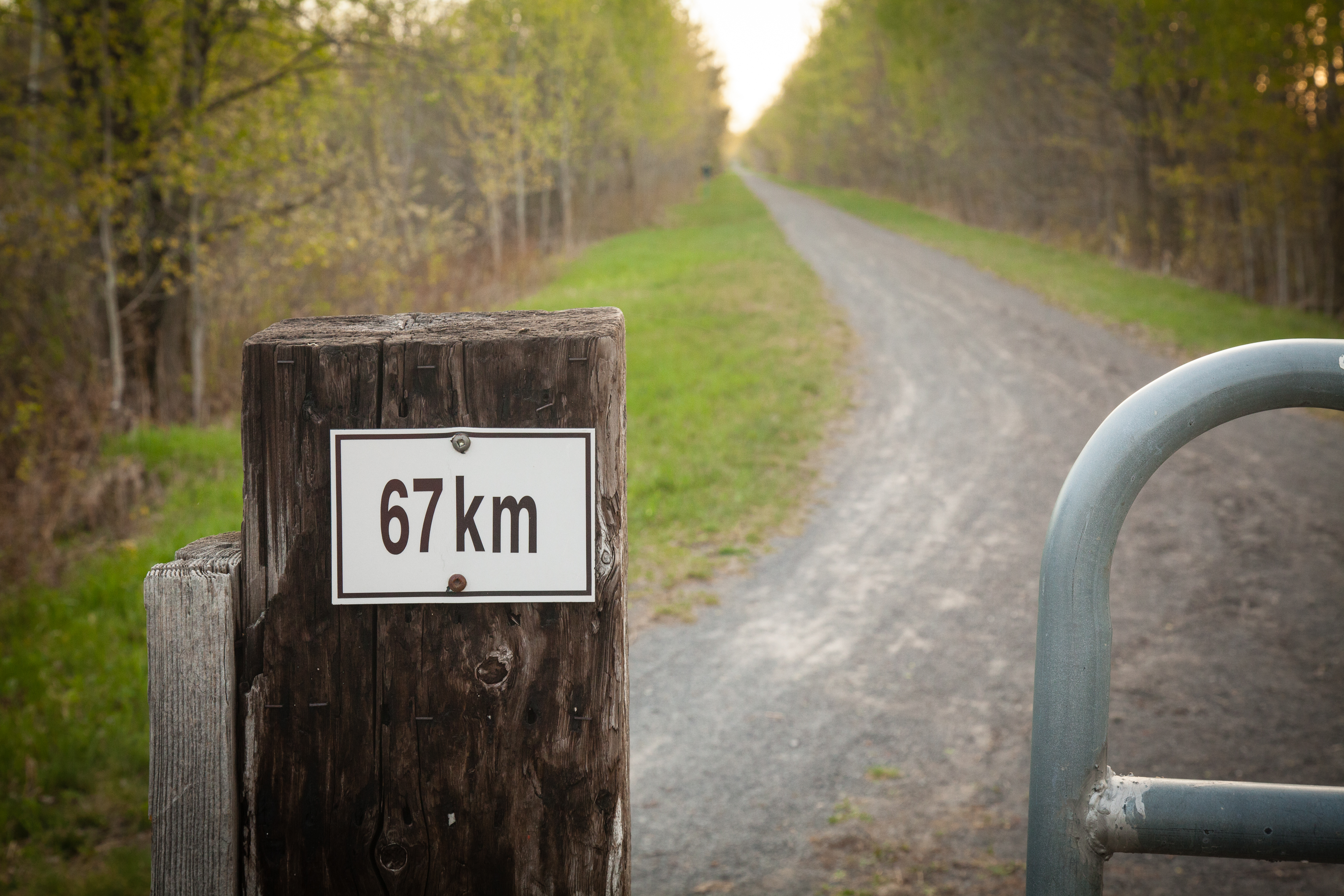 Outdoor trail sign indicating 67 km