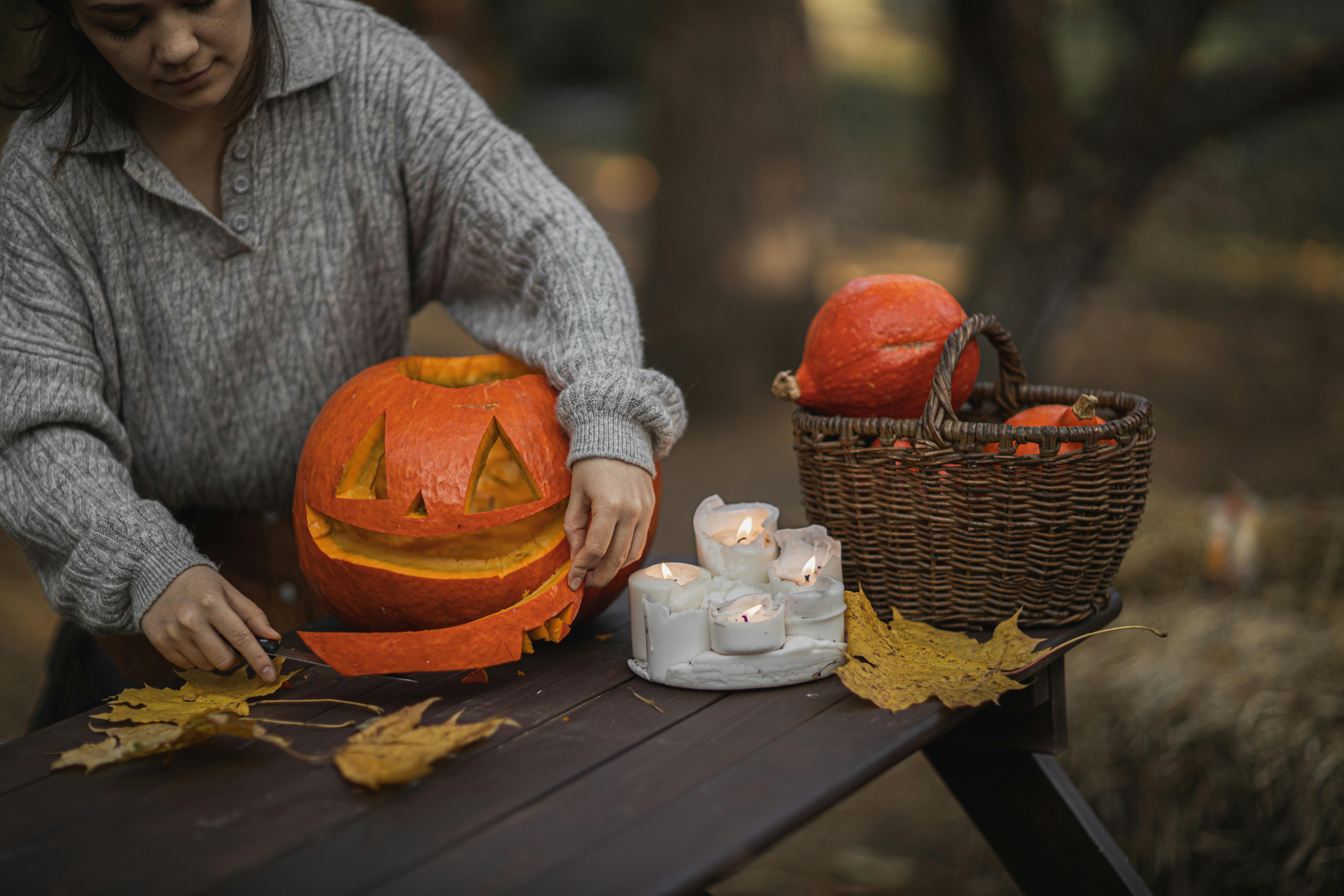 Pumpkin carving at a picnic table