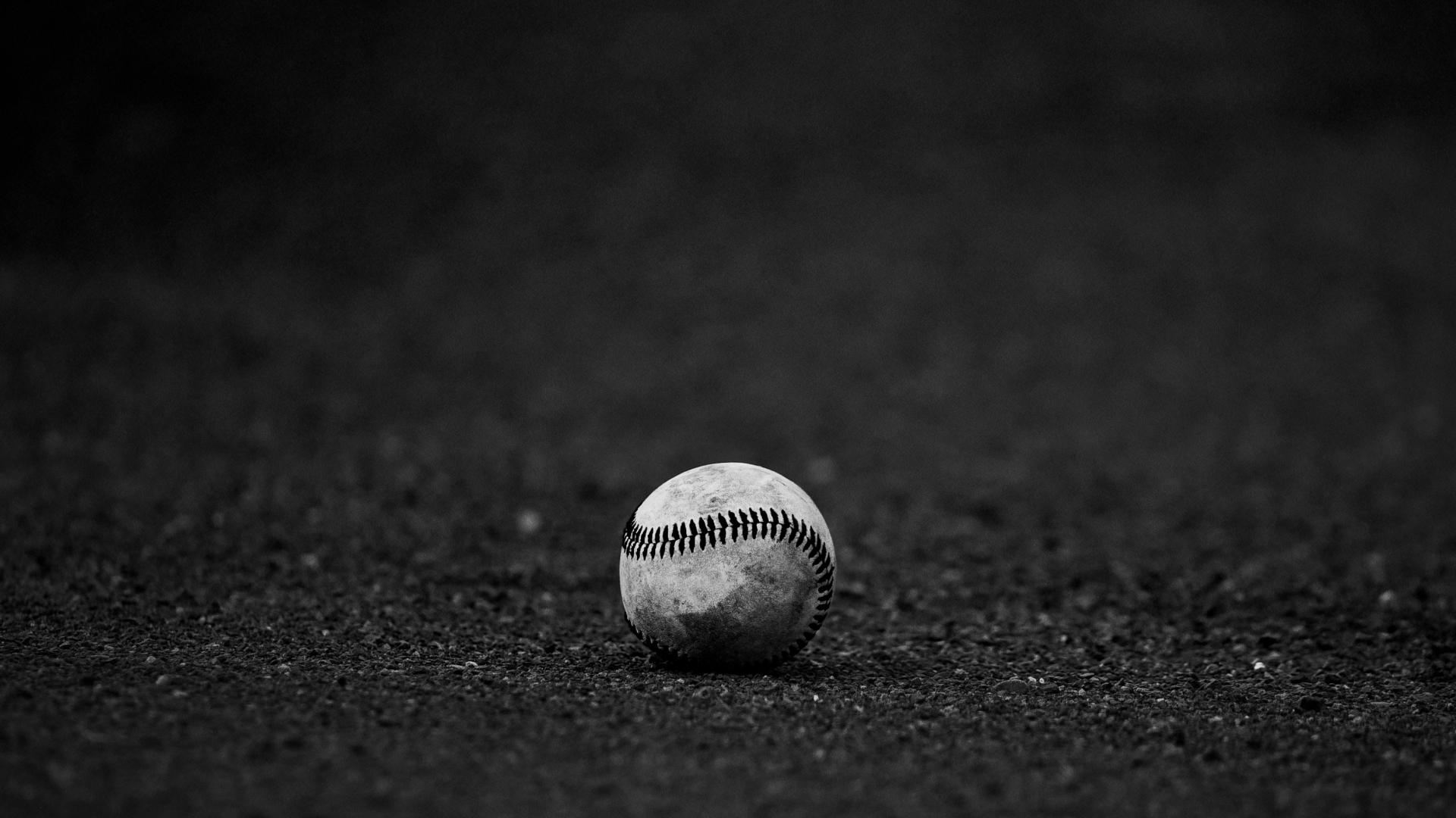 Baseball on a pitcher's mound under a clear blue sky.