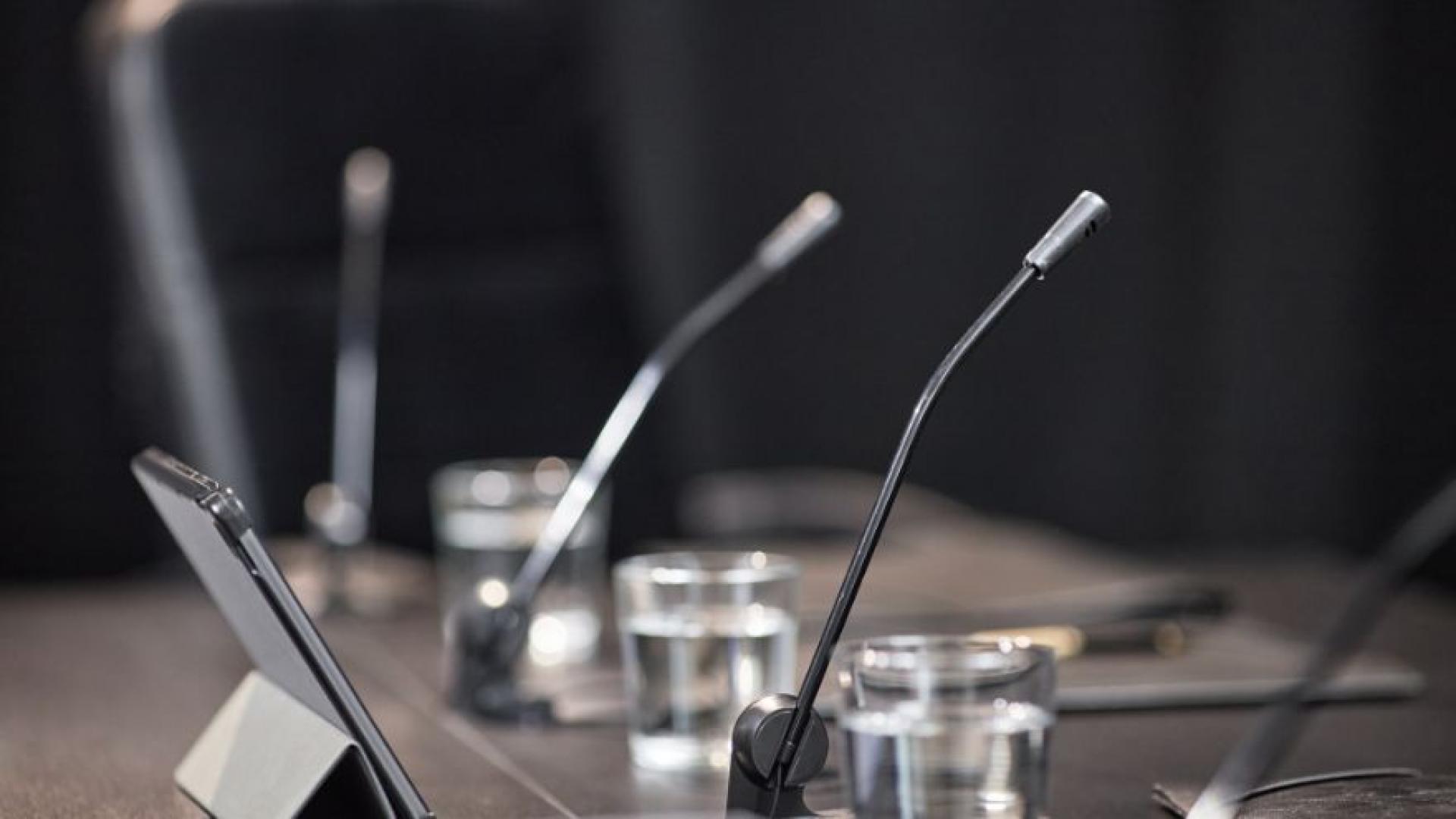Table dans une salle de conférence avec des micros