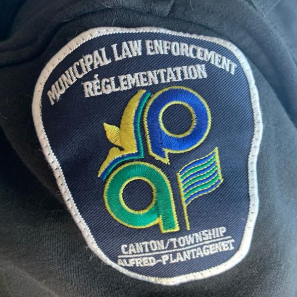 Municipal law enforcement patch on dark fabric.