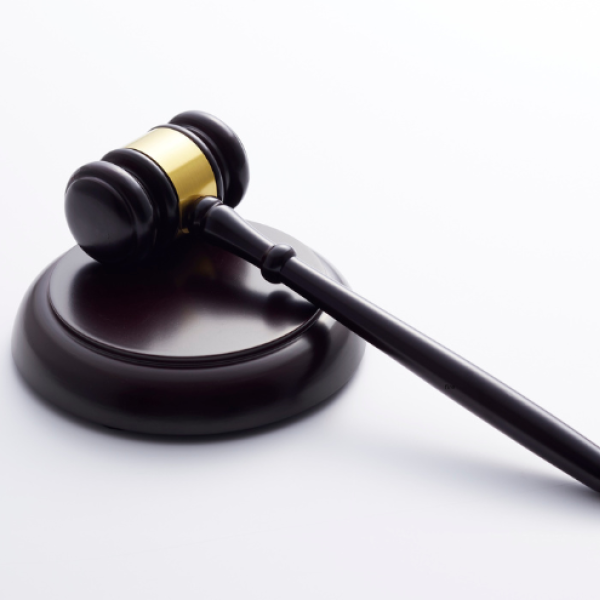 Black and gold gavel on a white background