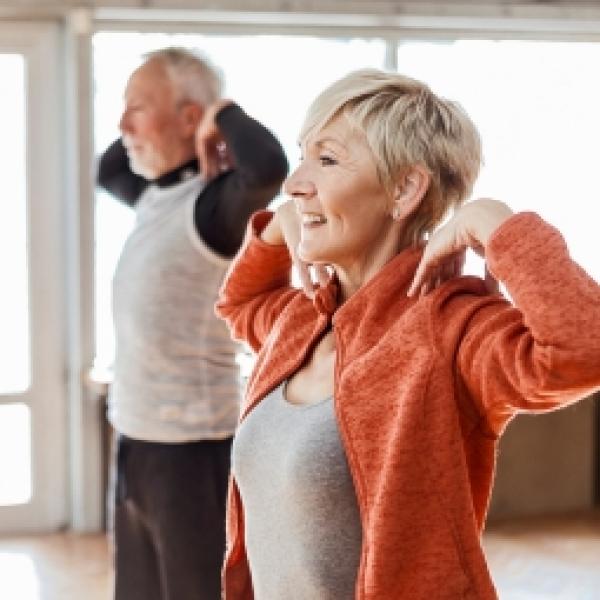 Older woman and older man stretching 